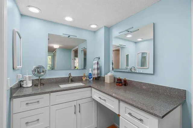 a bathroom with double sink and a mirror