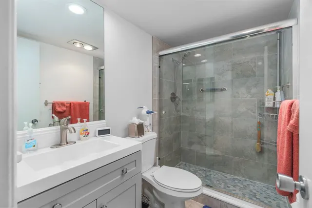 a bathroom with a sink mirror toilet and shower