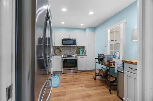 a kitchen with cabinets and a stainless steel appliances
