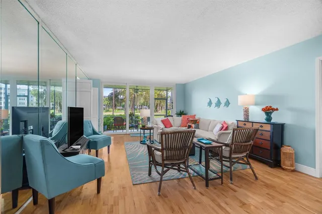 a dining room with furniture a fireplace and wooden floor