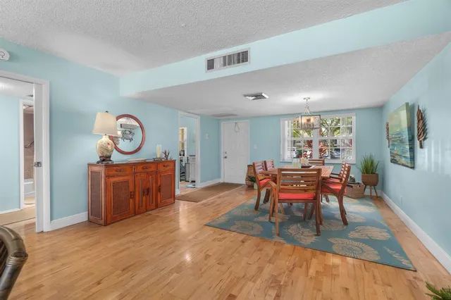 a living room with furniture a window and a dining table