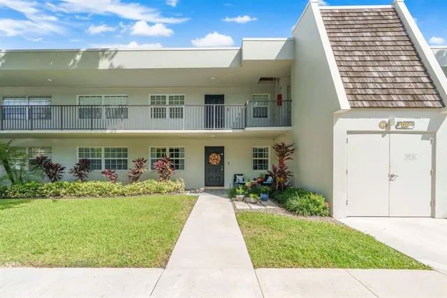 a front view of a building with garden