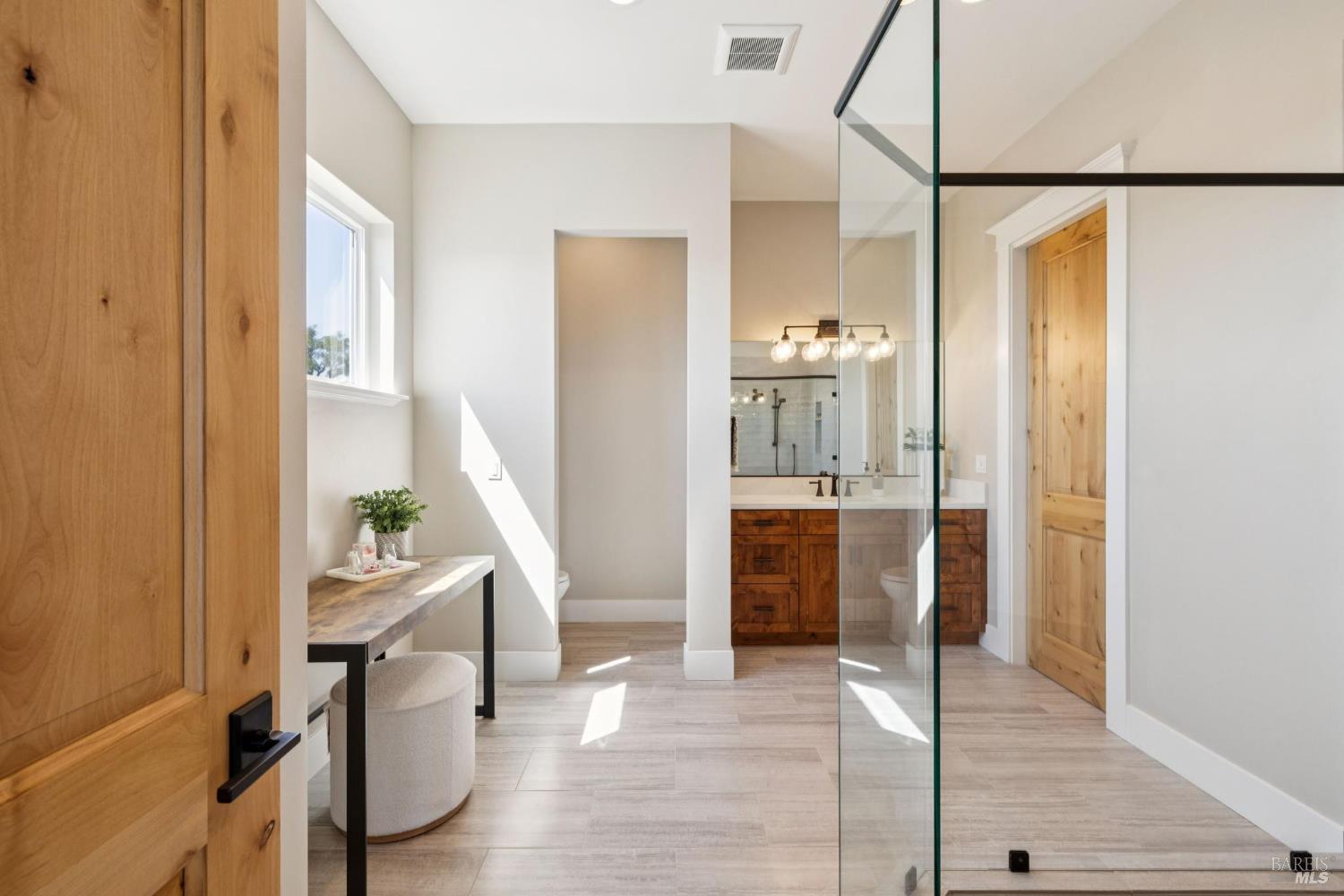 3882 Royal Manor Place Santa Rosa, CA 95404 - Photo 61 of 98 Upstairs primary full bathroom boasts a glass door shower with dual shower heads, a dual pane window, oil rubbed bronze Moen fixtures, recessed lighting and a second door that flows into the hallway.
