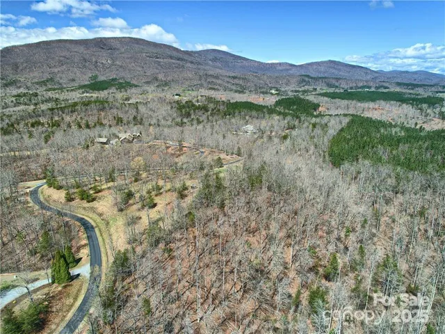 a view of a lush green hillside and a building