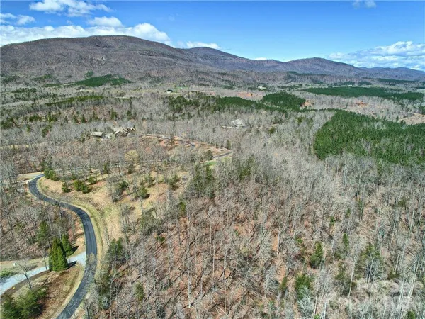 a view of a lush green hillside and a building