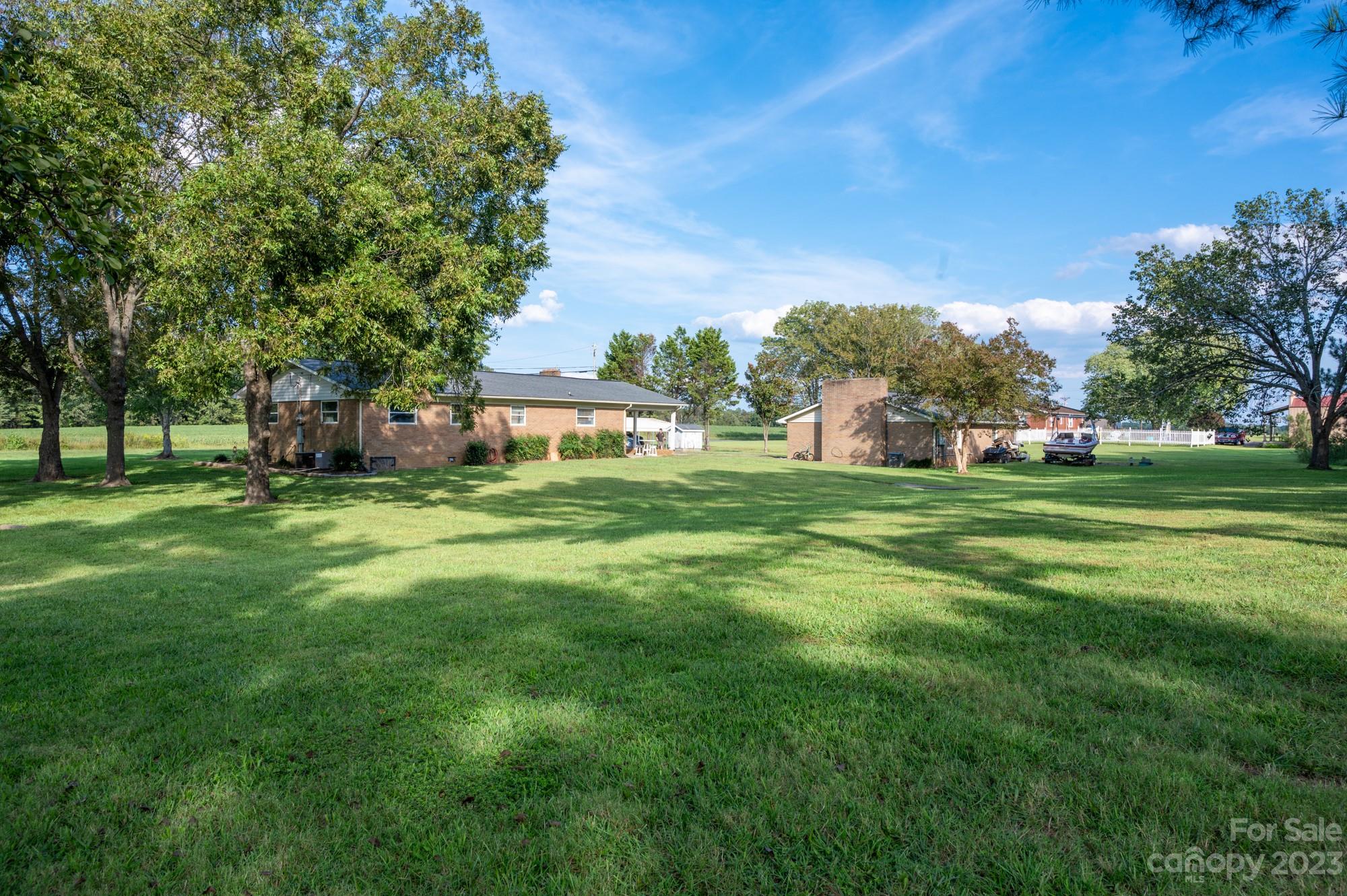 6600 Barrier Store Road Mount Pleasant, NC 28124 - Photo 2 of 21 a backyard of a house with lots of green space and fountain