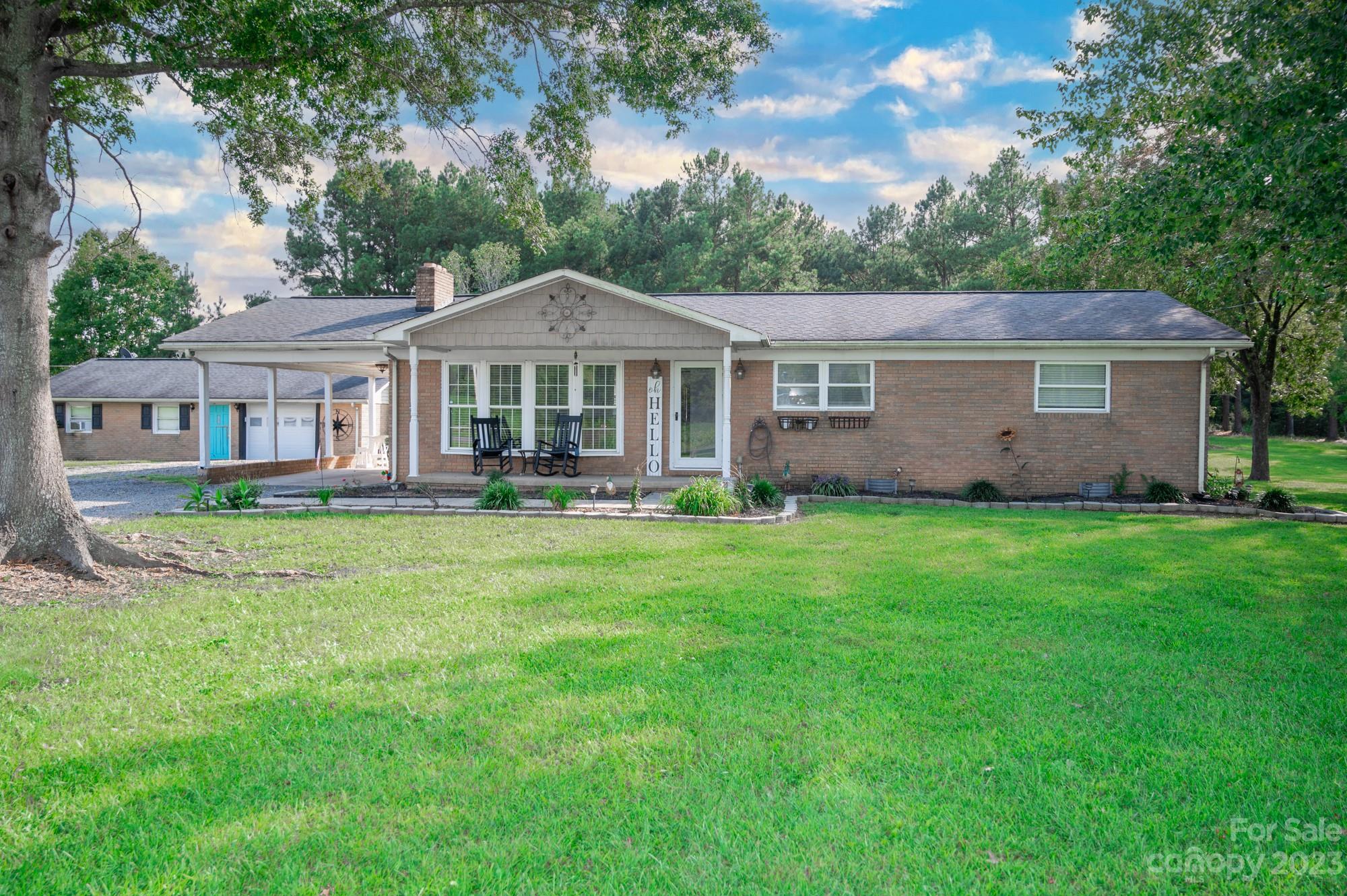 6600 Barrier Store Road Mount Pleasant, NC 28124 - Photo 3 of 21 a front view of a house with a garden and trees