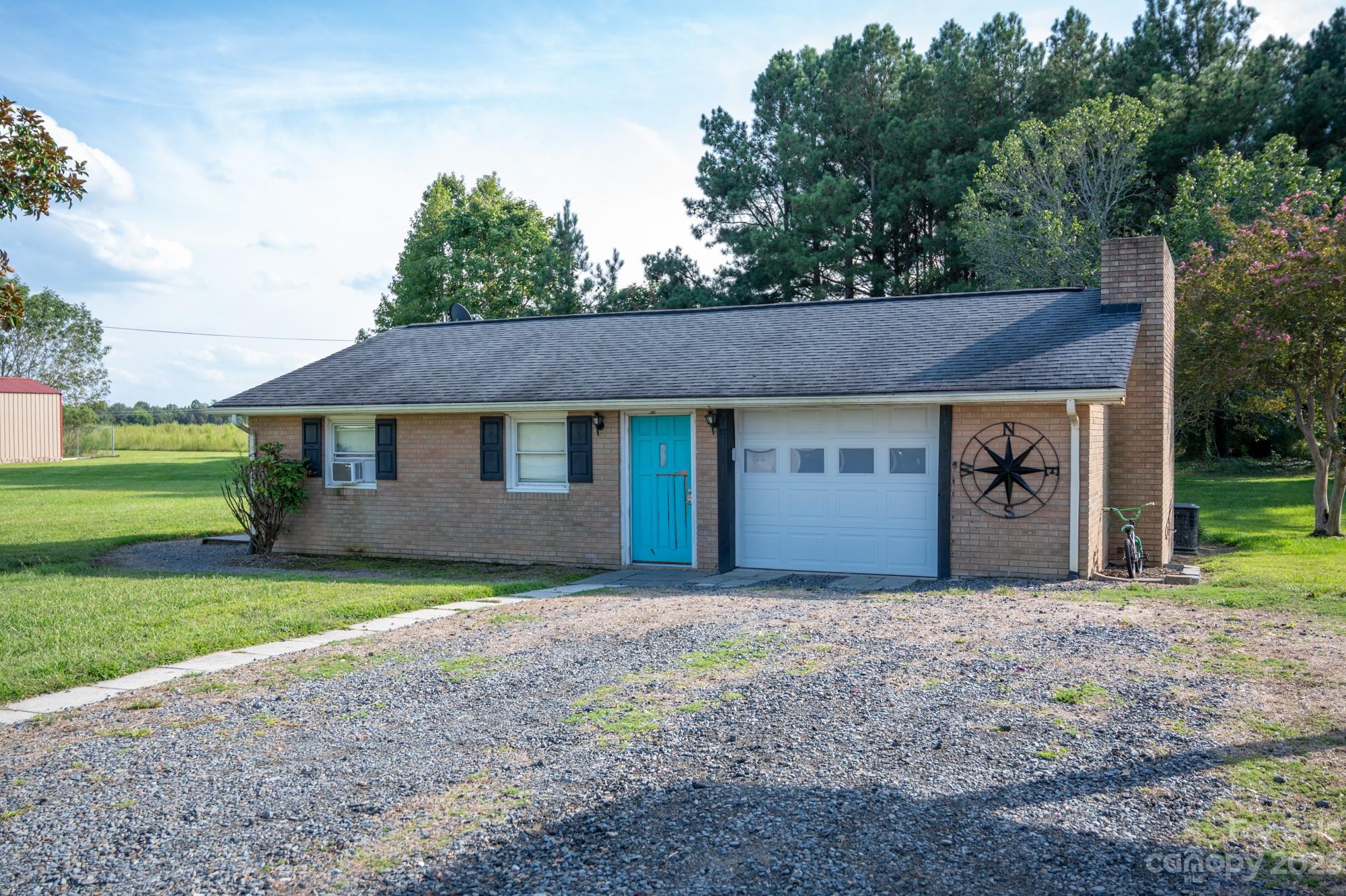 6600 Barrier Store Road Mount Pleasant, NC 28124 - Photo 8 of 21 a front view of a house with a garden and yard
