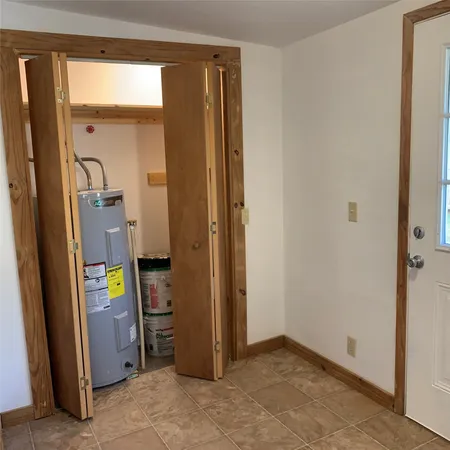 a bathroom with a window and wooden floor