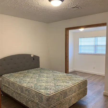 a bathroom with a glass door shower and a toilet