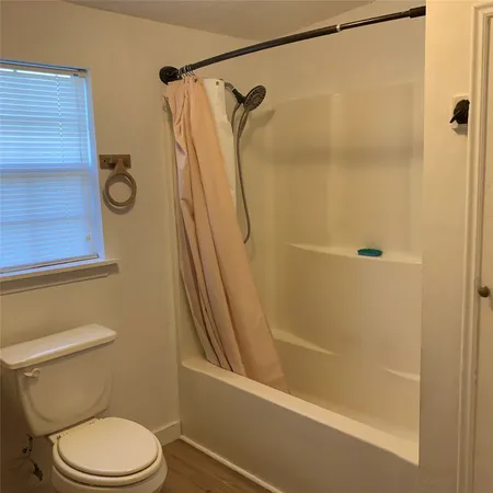 a bathroom with a glass shower door