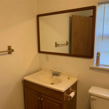 a view of a small space with wooden floor and a window