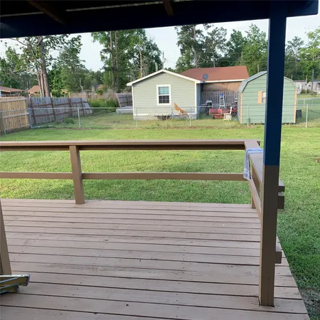 a view of a yard with a wooden fence