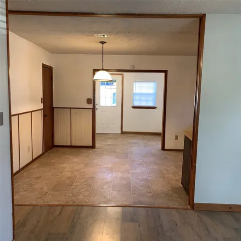 a kitchen with granite countertop a stove a sink and a refrigerator