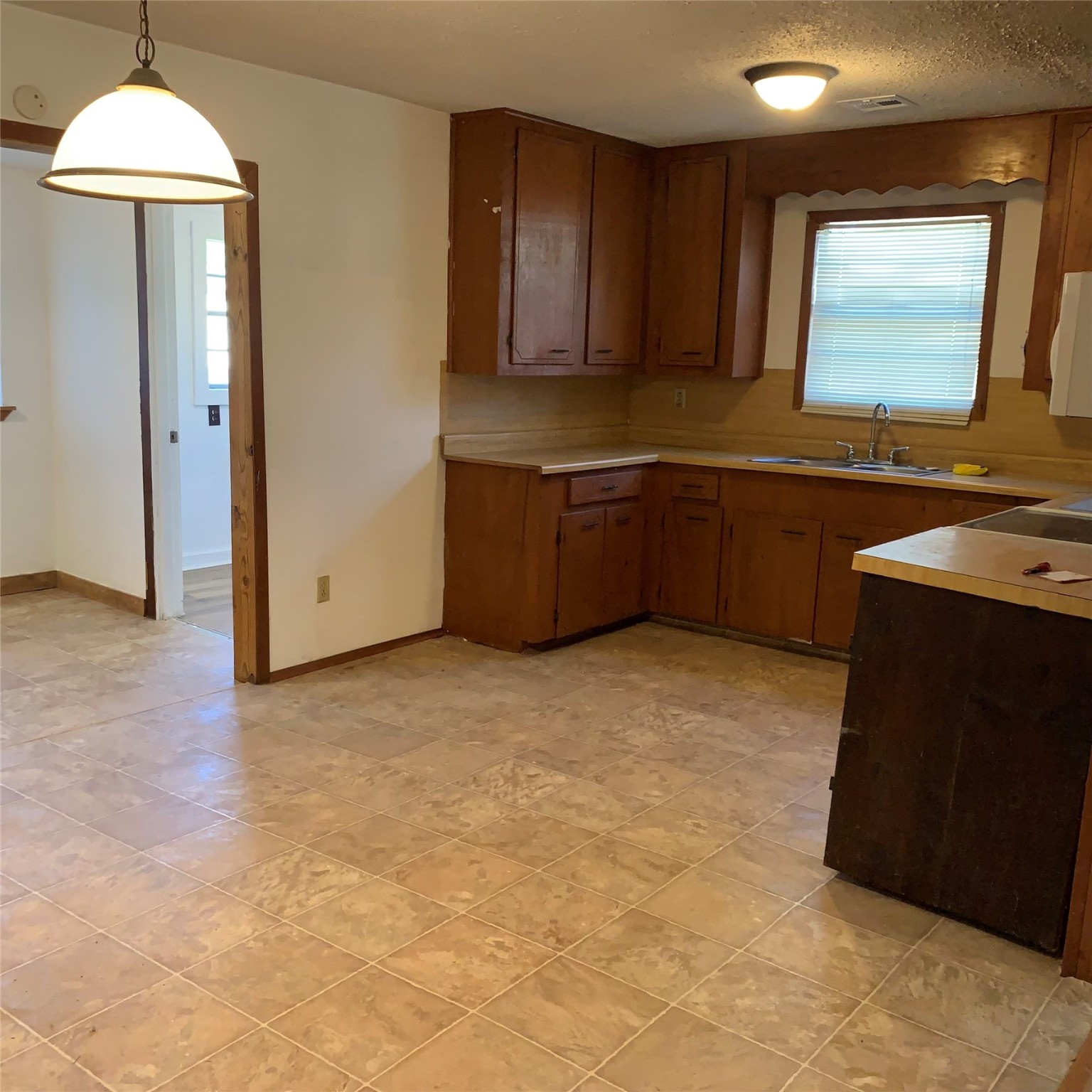 324 Persimmon Road Onalaska, TX 77360 - Photo 8 of 41 a kitchen with granite countertop a stove a sink and a refrigerator