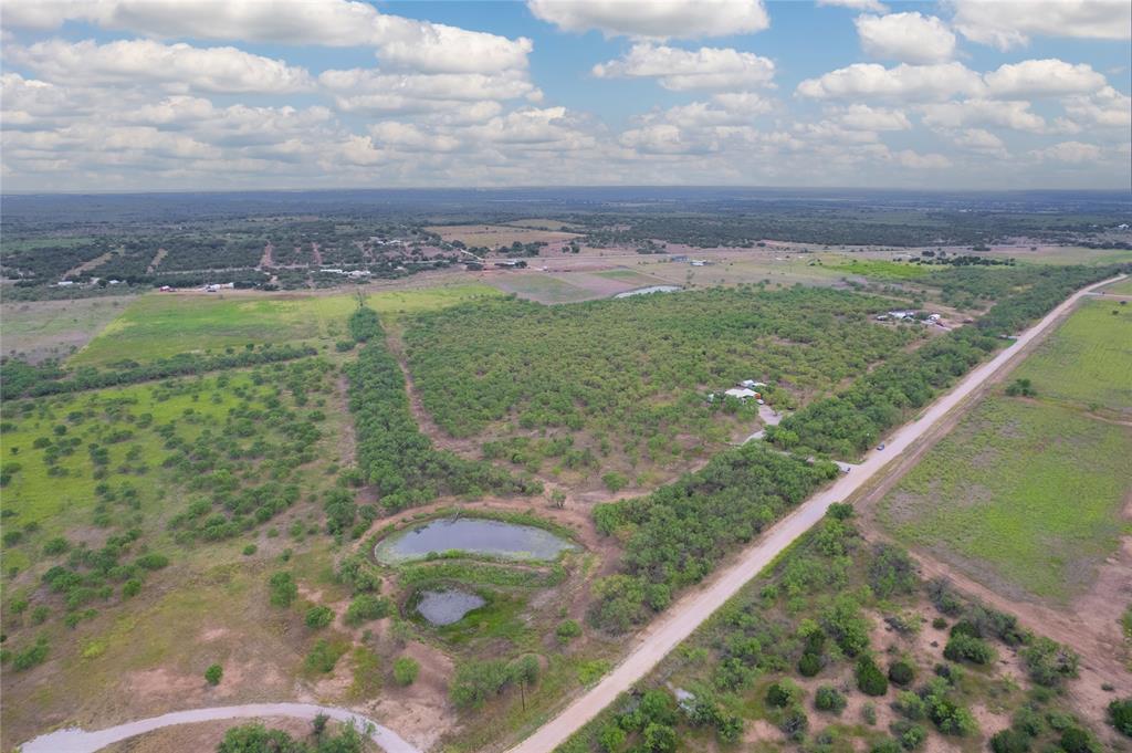 15905 County Road 211 Brookesmith, TX 76827 - Photo 5 of 23 a view of a lake with a big yard