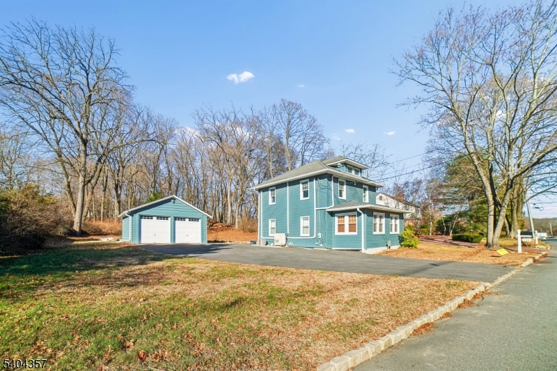 169 Diamond Spring Road Denville, NJ 07834 - Photo 1 of 31 a front view of a house with large trees and covered with yard