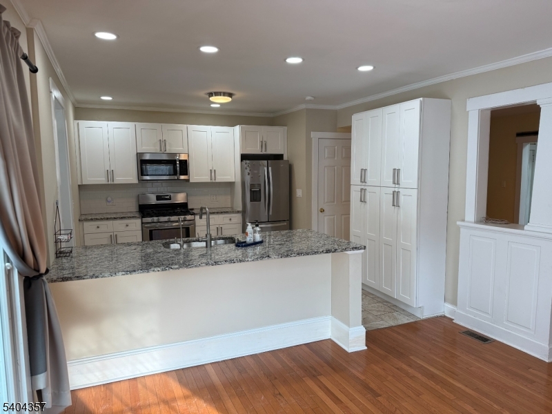 169 Diamond Spring Road Denville, NJ 07834 - Photo 13 of 31 a large kitchen with stainless steel appliances a large counter top a stove a sink and a refrigerator