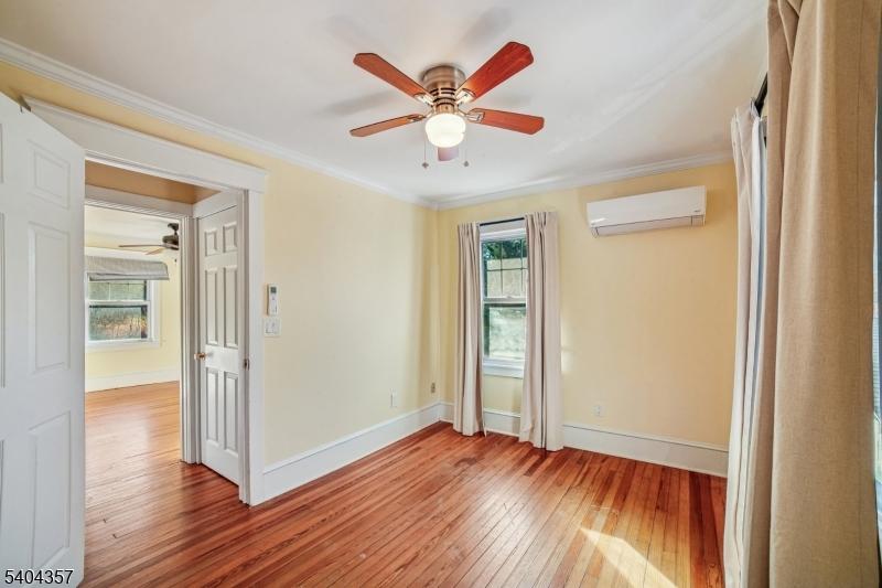169 Diamond Spring Road Denville, NJ 07834 - Photo 20 of 31 wooden floor in an empty room with a window