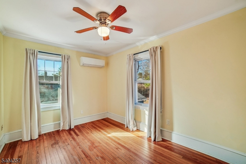 169 Diamond Spring Road Denville, NJ 07834 - Photo 21 of 31 an empty room with wooden floor and door