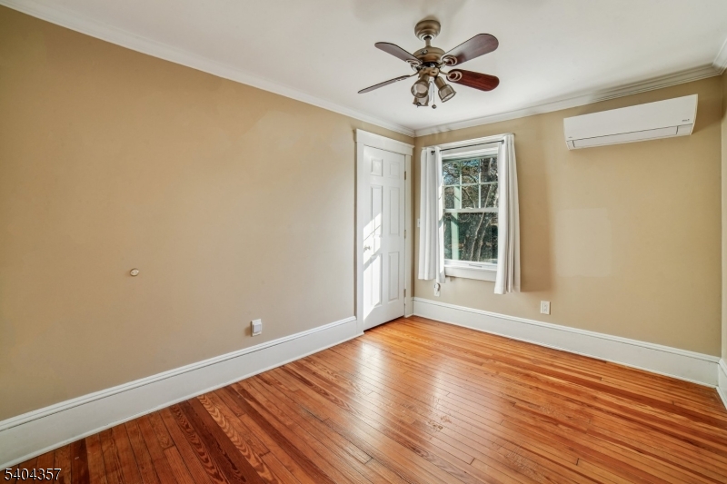 169 Diamond Spring Road Denville, NJ 07834 - Photo 24 of 31 a view of an empty room with wooden floor and a window