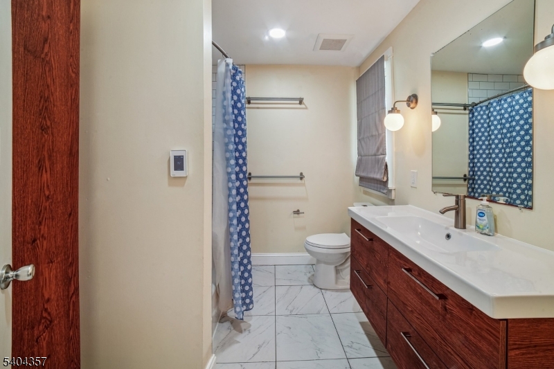 169 Diamond Spring Road Denville, NJ 07834 - Photo 26 of 31 a bathroom with a sink a toilet and shower
