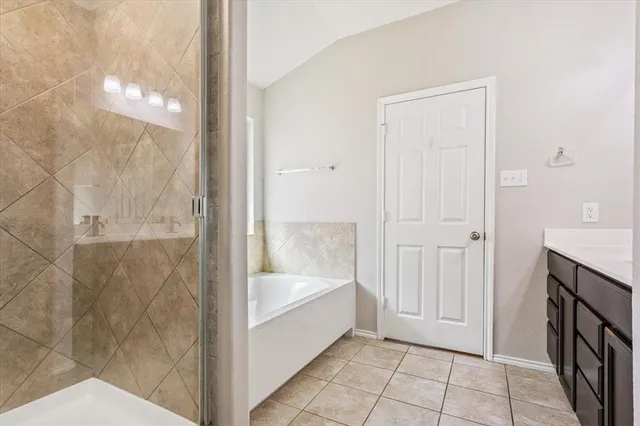 a bathroom with a bathtub and shower