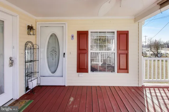 a view of a room with wooden floor and windows