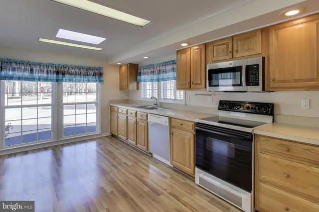 a large kitchen with a lot of counter space and a wooden floors