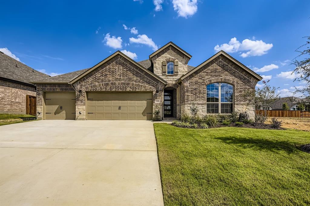 1809 Flowerfield Lane Mansfield, TX 76063 - Photo 1 of 29 French country home with brick siding, an attached garage, driveway, and stone siding