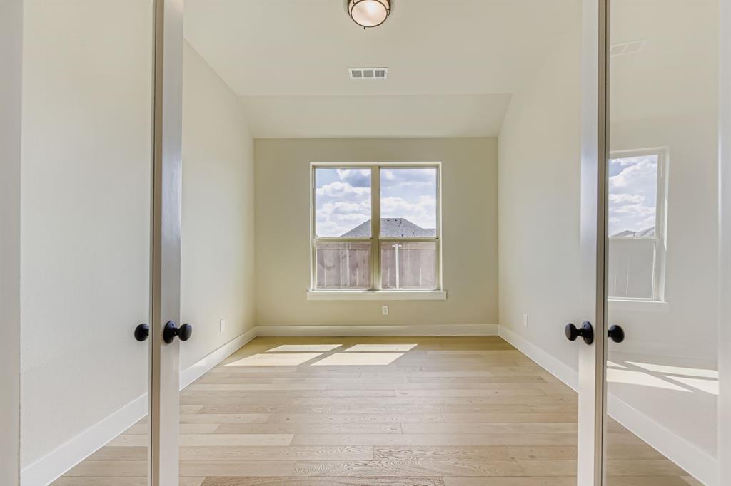 1809 Flowerfield Lane Mansfield, TX 76063 - Photo 14 of 29 Spare room featuring light wood-type flooring and french doors