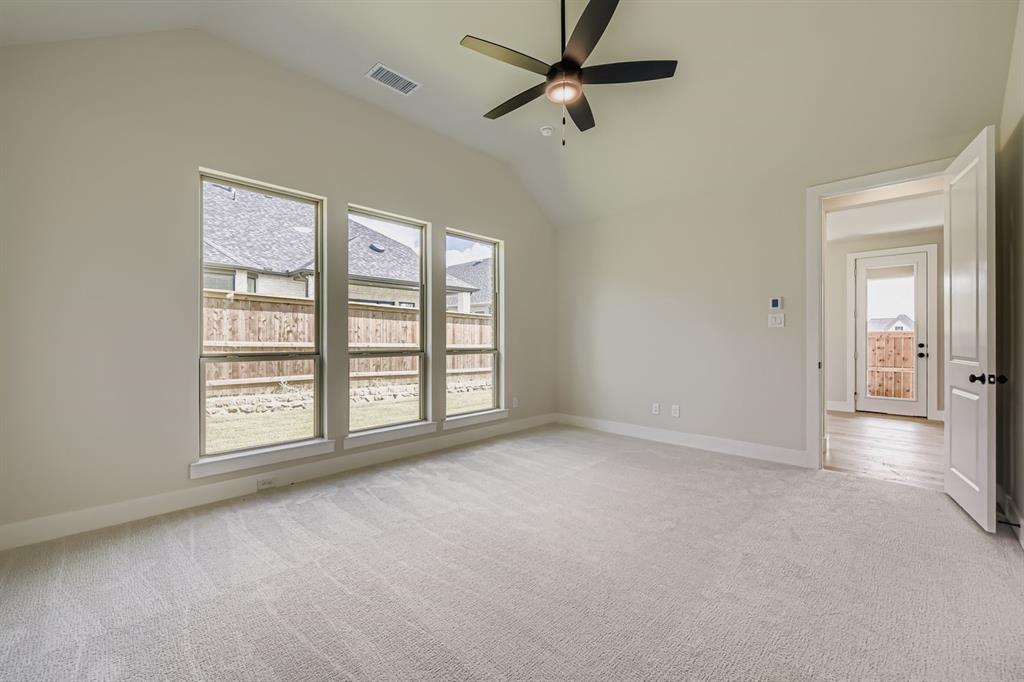 1809 Flowerfield Lane Mansfield, TX 76063 - Photo 17 of 29 Unfurnished bedroom featuring lofted ceiling, light carpet, and ceiling fan