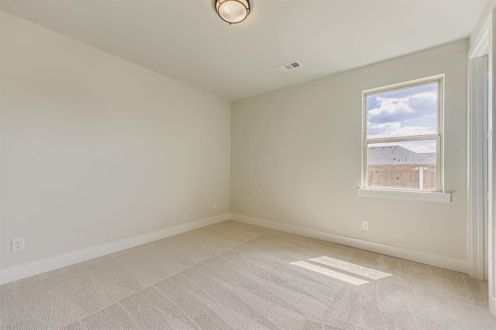 1809 Flowerfield Lane Mansfield, TX 76063 - Photo 22 of 29 Spare room featuring baseboards and light carpet