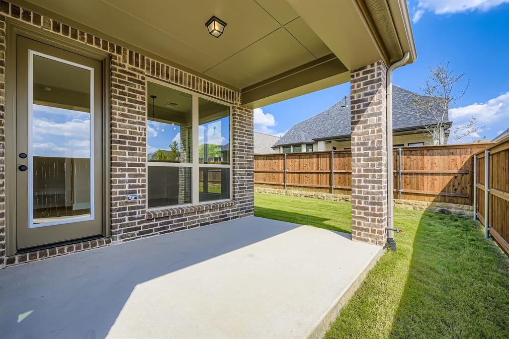 1809 Flowerfield Lane Mansfield, TX 76063 - Photo 26 of 29 Fenced backyard featuring a patio area