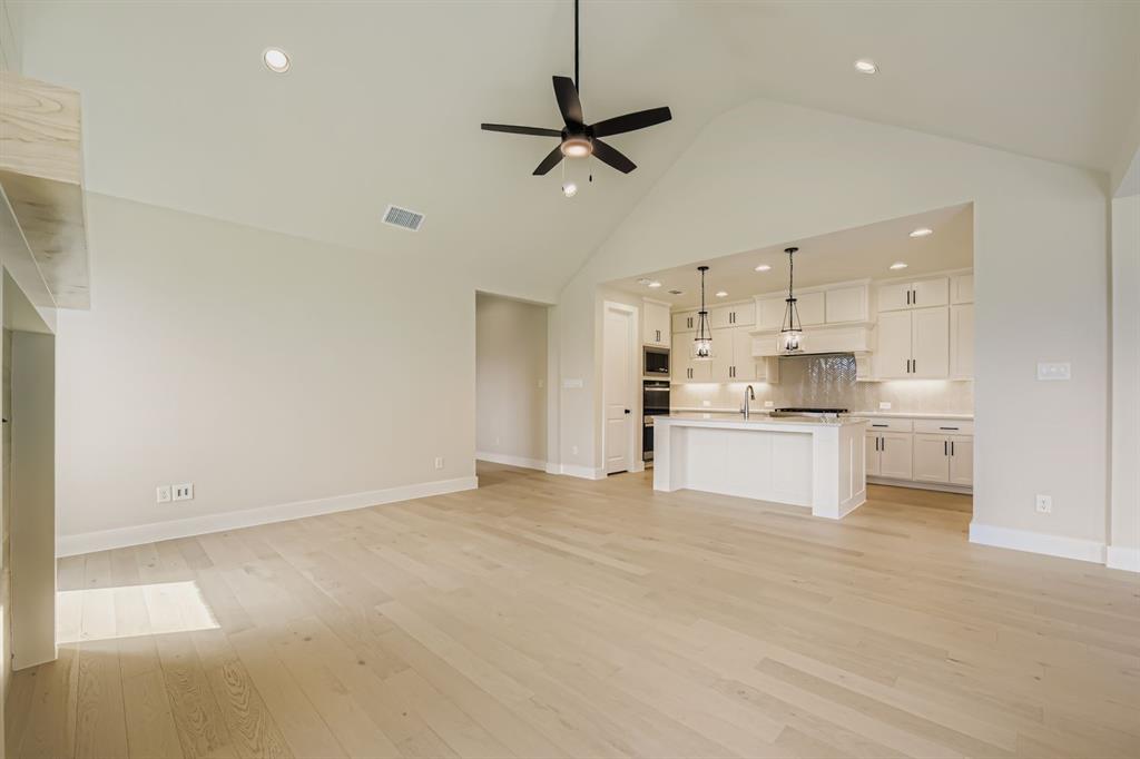 1809 Flowerfield Lane Mansfield, TX 76063 - Photo 7 of 29 Unfurnished living room featuring light wood finished floors, high vaulted ceiling, recessed lighting, and ceiling fan