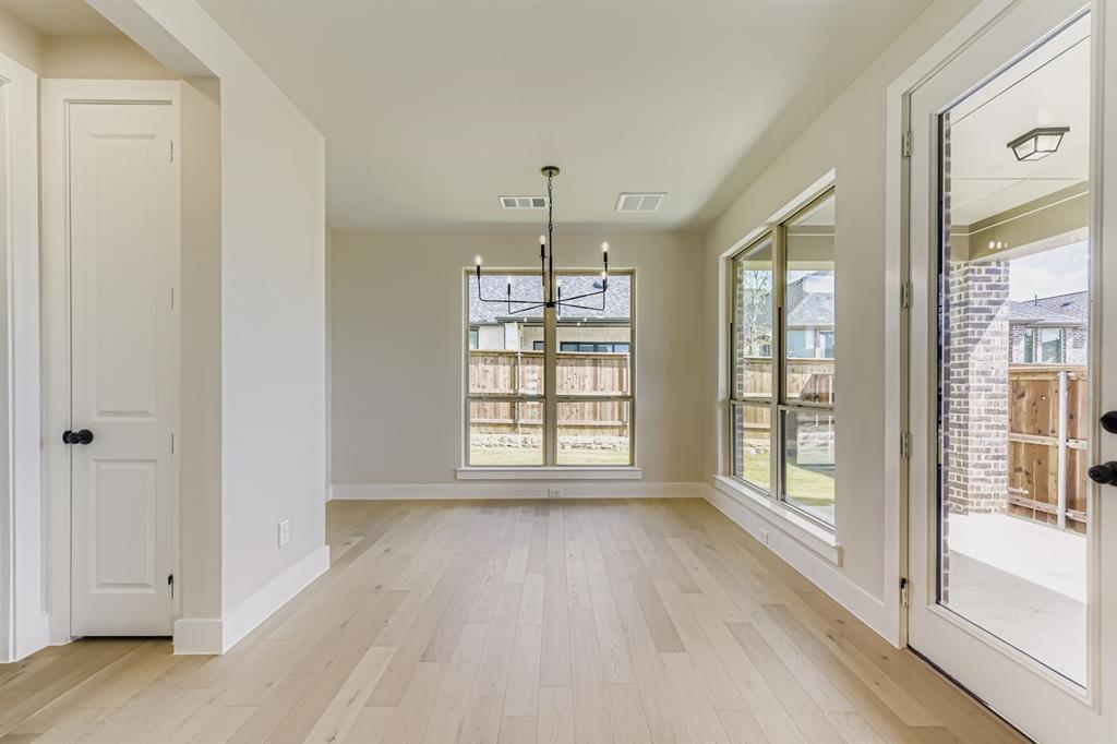 1809 Flowerfield Lane Mansfield, TX 76063 - Photo 8 of 29 Unfurnished dining area with a chandelier and light wood finished floors