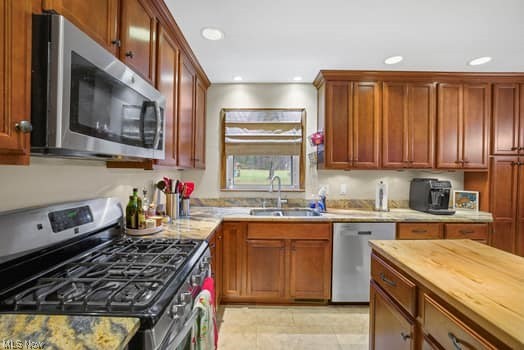 4618 South Arlington Road Uniontown, OH 44685 - Photo 12 of 31 Kitchen with wooden counters, sink, stainless steel appliances, and light tile floors