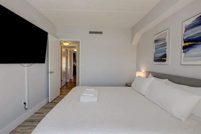 a bedroom with a bed and a flat screen tv