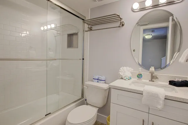 a bathroom with a sink vanity mirror and toilet