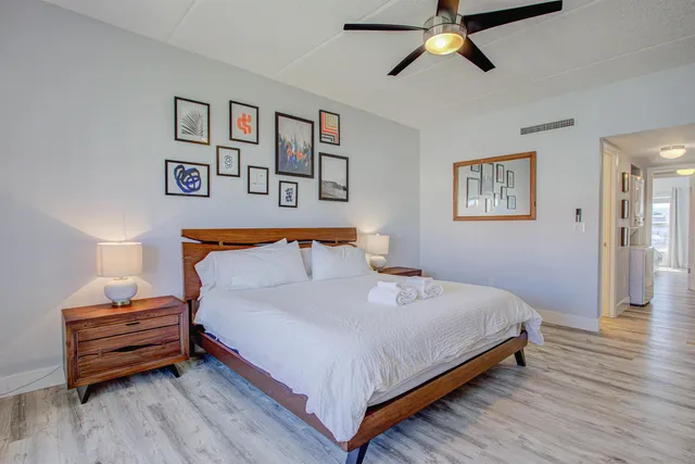 a bedroom with a bed and wooden floor