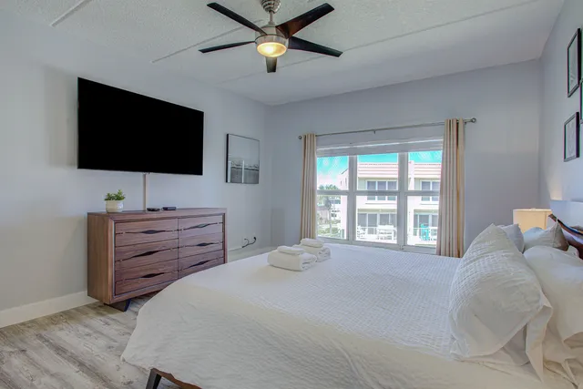 a bedroom with a bed and a flat screen tv