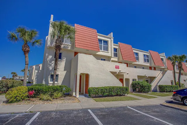 a view of a patio with table and chairs