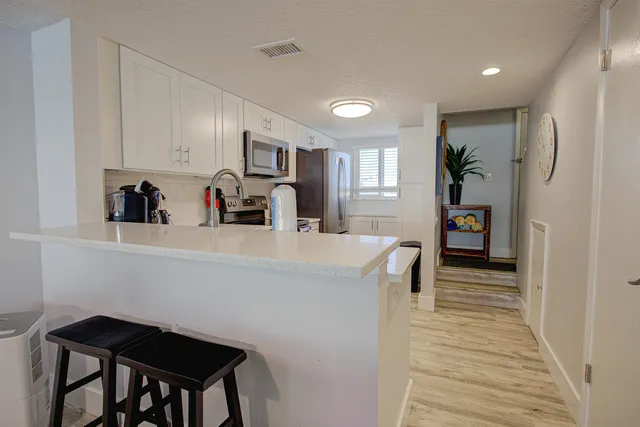 a kitchen with refrigerator and cabinets