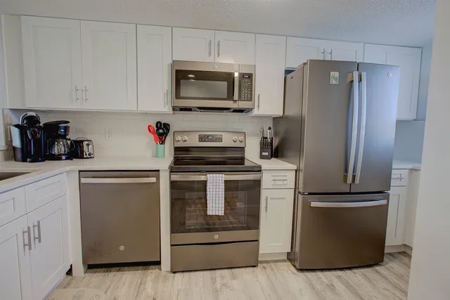 a kitchen with a refrigerator stove and microwave