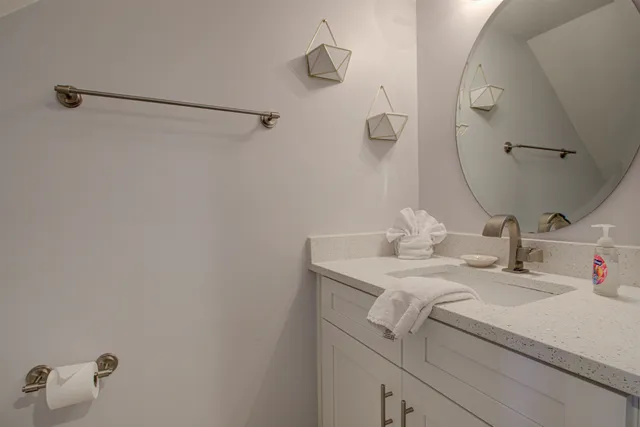 a bathroom with a sink and vanity