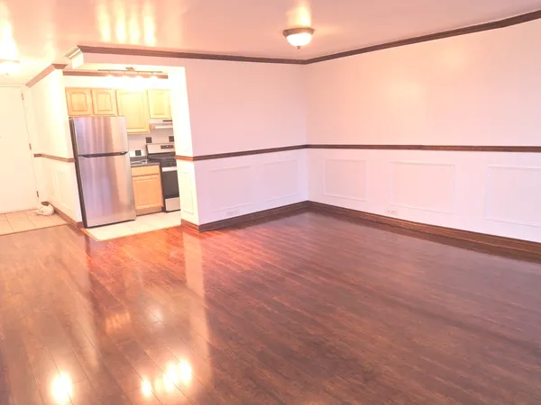 a view of a room with wooden floor