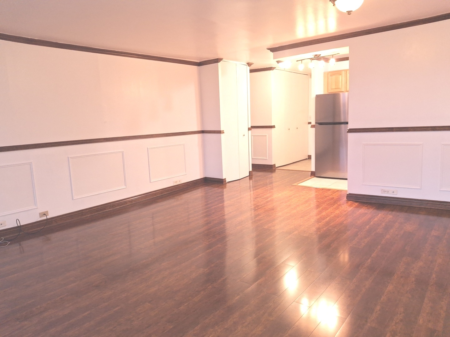 2605 South Indiana Avenue, Unit 1909 Chicago, IL 60616 - Photo 5 of 19 a view of a big room with wooden floor and windows