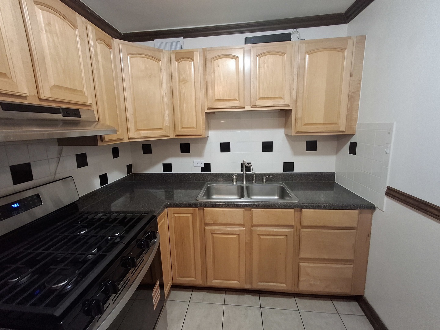 2605 South Indiana Avenue, Unit 1909 Chicago, IL 60616 - Photo 7 of 19 a kitchen with stainless steel appliances granite countertop a sink stove and cabinets