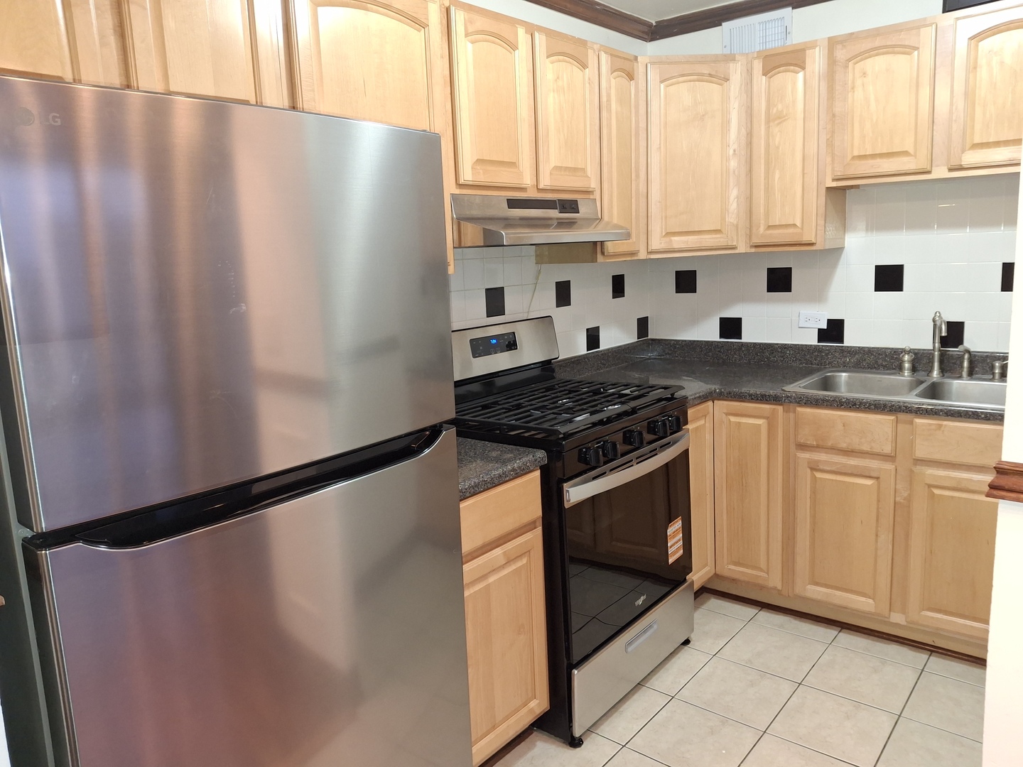 2605 South Indiana Avenue, Unit 1909 Chicago, IL 60616 - Photo 8 of 19 a kitchen with stainless steel appliances granite countertop white cabinets a refrigerator and a sink