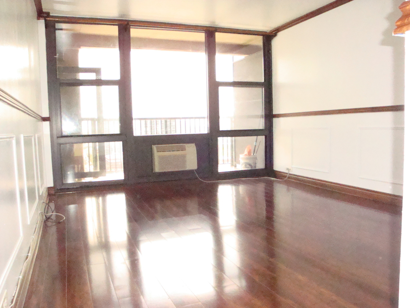 2605 South Indiana Avenue, Unit 1909 Chicago, IL 60616 - Photo 9 of 19 a view of an empty room with wooden floor and a window